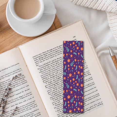 Eco-friendly floral patterned bookmark on open book beside cup of coffee and pen