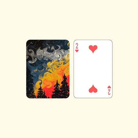 Colorful nature-inspired playing card featuring trees and a painted sky