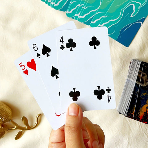 Scenic forest playing card with night sky, smoke swirls, and fiery hues.