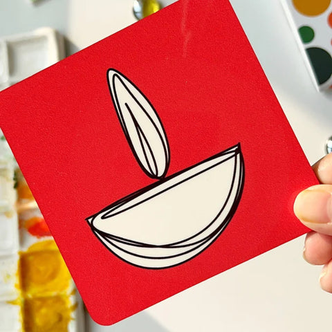 "Red and mustard coasters with contemporary Diwali diya illustrations"

