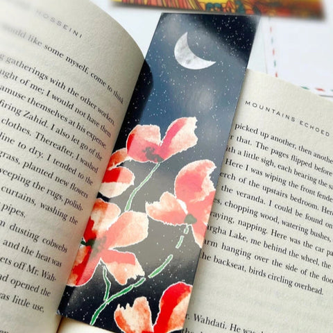 "Hand-painted floral bookmark featuring crescent moon and night sky"