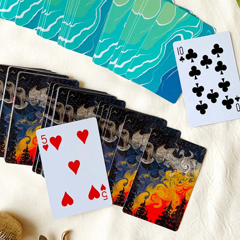 Vibrant forest-themed playing card featuring a colorful sunset and swirling smoke