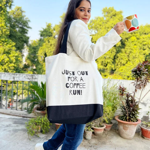 Stylish and sturdy coffee-themed tote bag held outdoors on a sunny day.