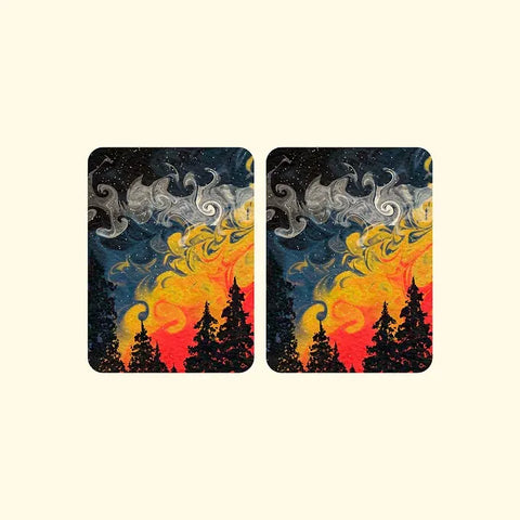 Hand-painted style playing card showcasing sunset, trees, and swirling stars