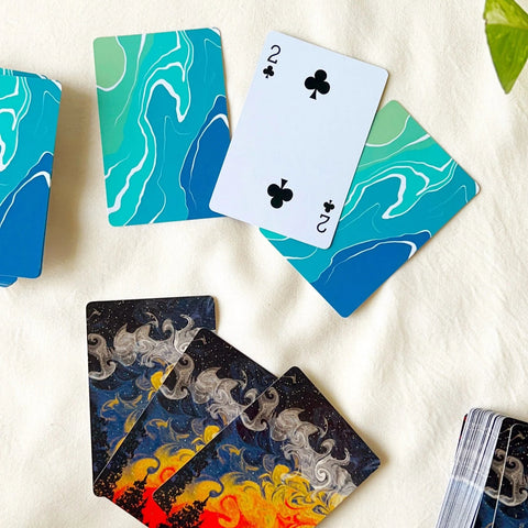 Artistic forest design on a playing card with stars and sunset blend.