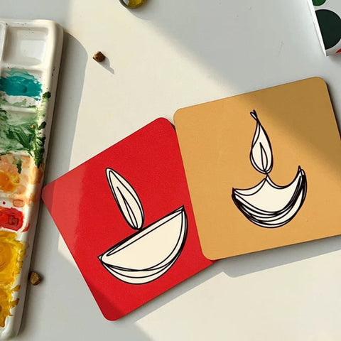 Hand-painted Diwali diya coasters with minimalist festive design.

