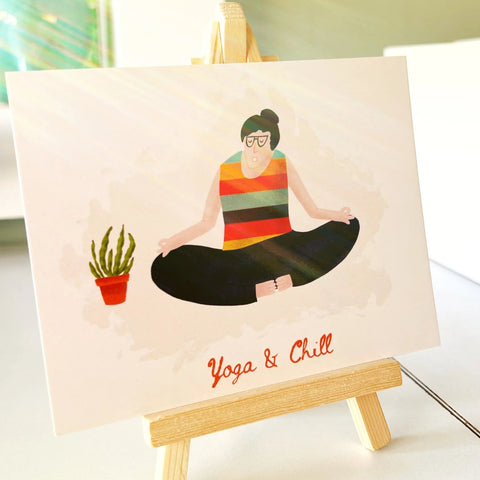 Cartoon woman in lotus pose with striped top and chill yoga text on art print