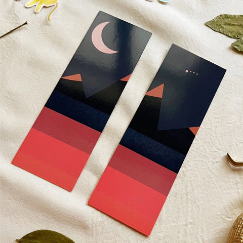 Elegant moon-themed bookmark placed inside an open book