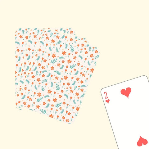 "Playing cards with pink floral pattern and botanical design"