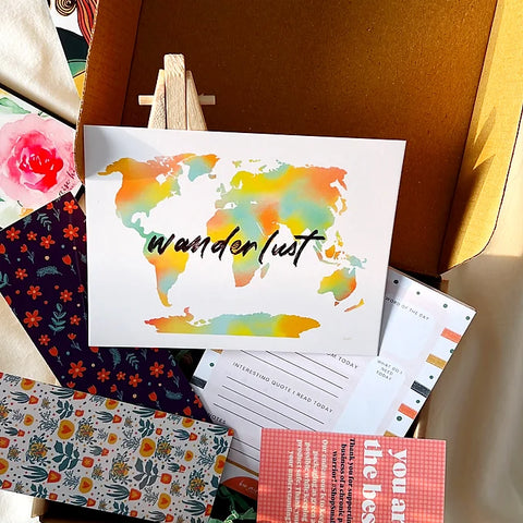 Travel-inspired stationery set including a world map print, daily gratitude sheet, and decorative designs