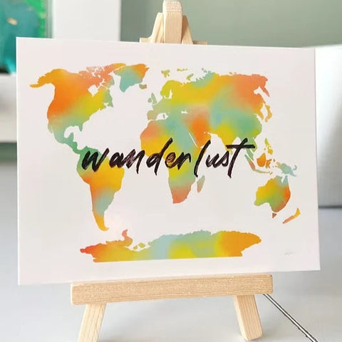 Wanderlust-themed desk art print with inspirational travel quote