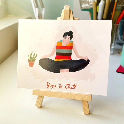 Illustrated desk art print of a woman meditating with “Yoga & Chill” caption.